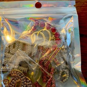 Jibitz fir Crocs.  Colorful Chanel logo and YSL and Gucci to decorate your croc